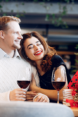 Couple dining with roses and red wine